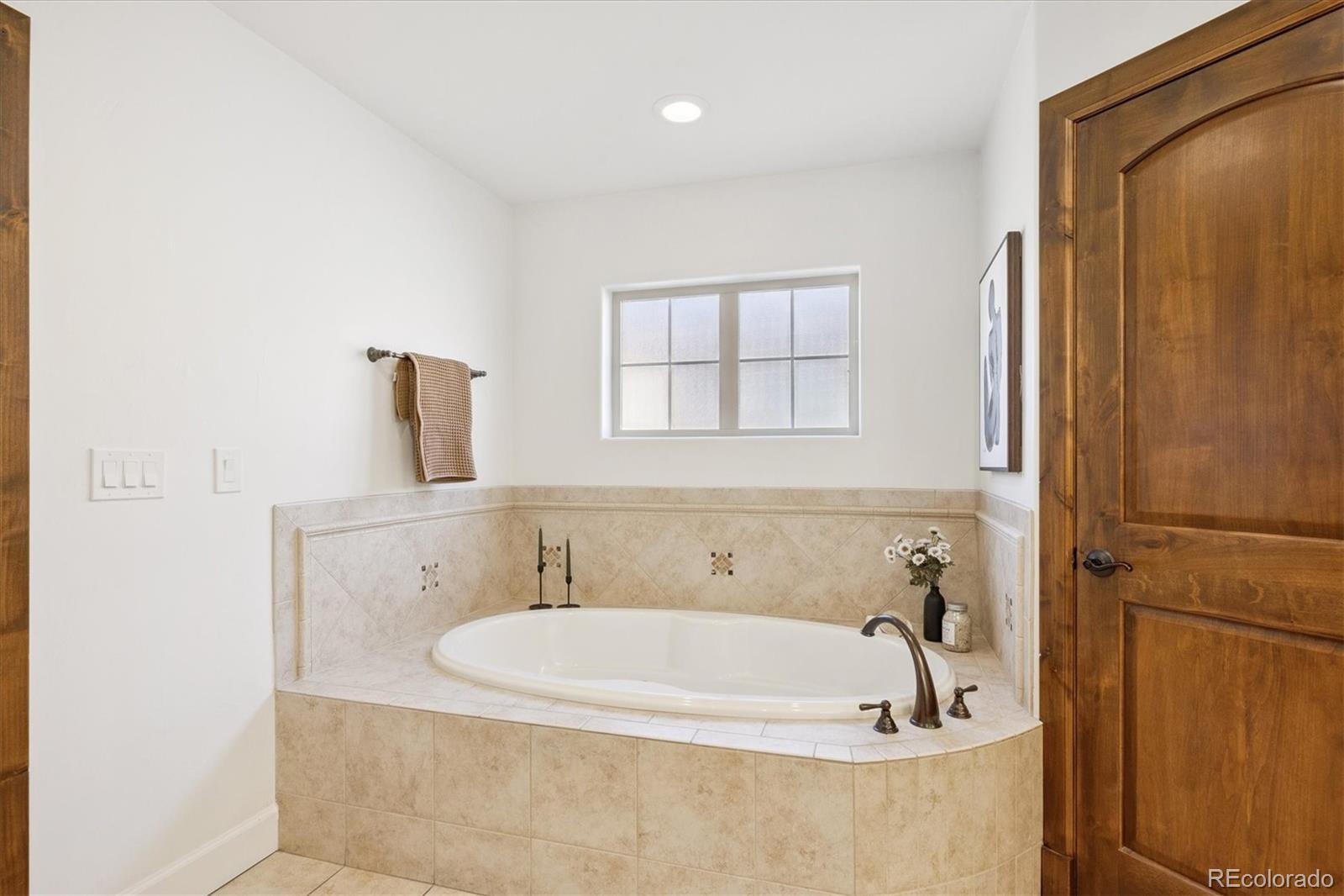 2415 South Madison Street Denver, CO 80210 - Photo 26 of 37 a bathroom with a tub and shower