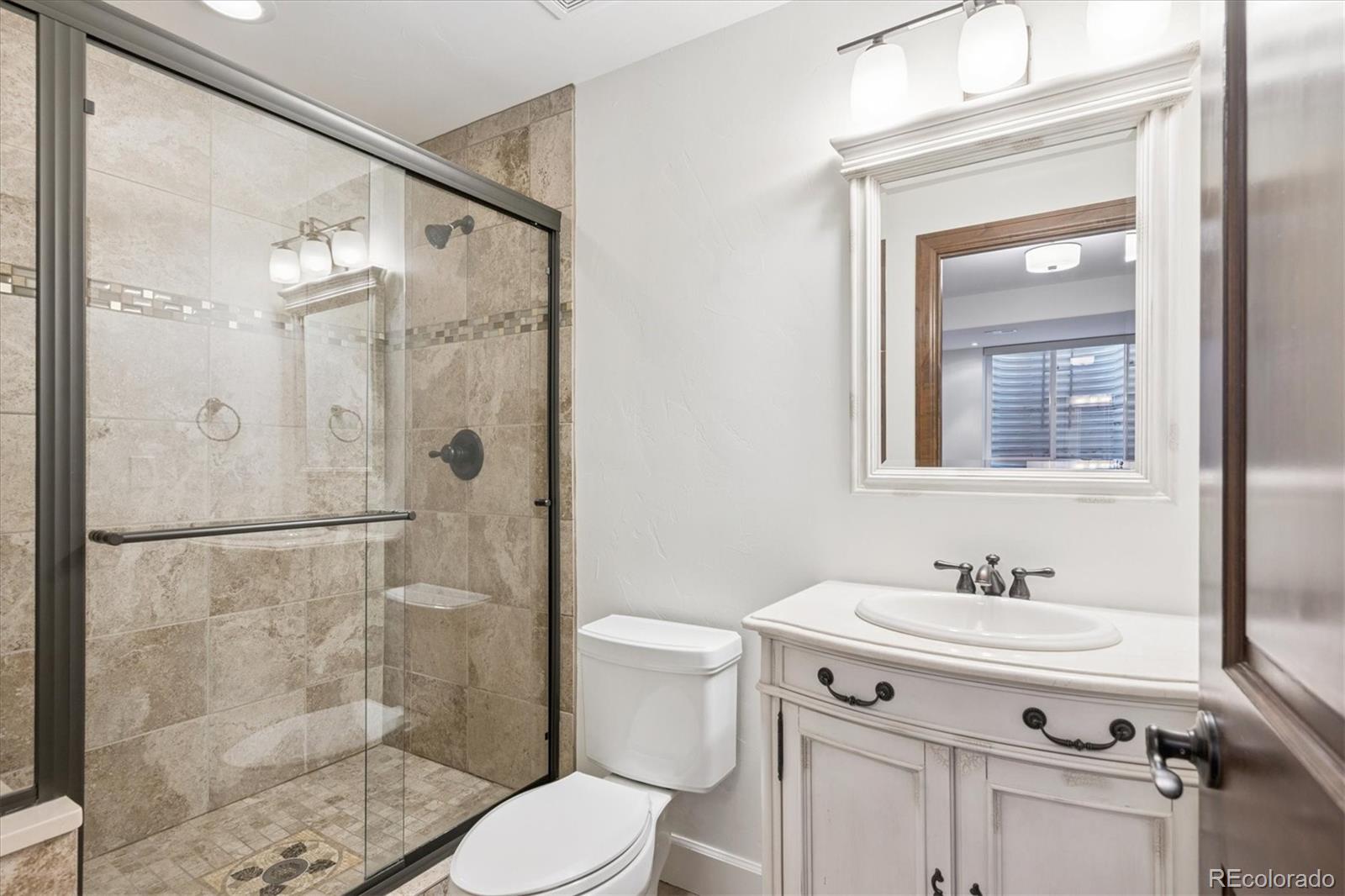 2415 South Madison Street Denver, CO 80210 - Photo 28 of 37 a bathroom with a sink toilet and shower