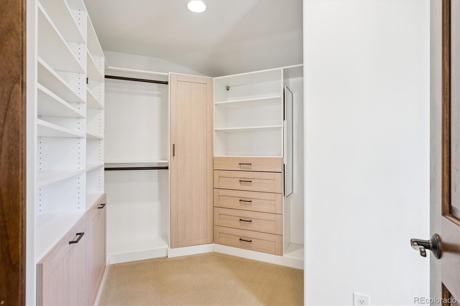 2415 South Madison Street Denver, CO 80210 - Photo 29 of 37 a view of walk in closet with empty racks