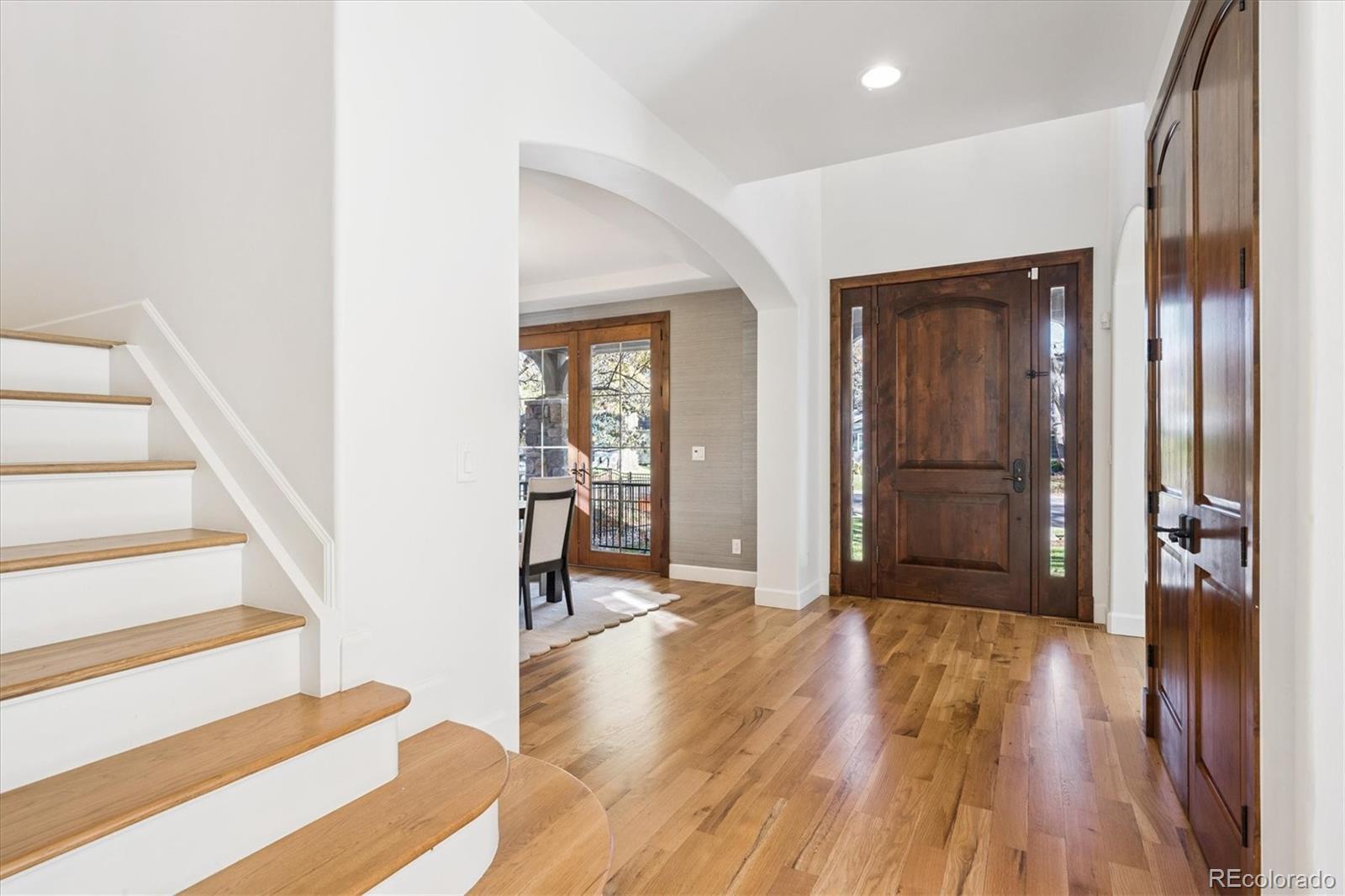 2415 South Madison Street Denver, CO 80210 - Photo 3 of 37 a view of entryway with wooden floor and stairs