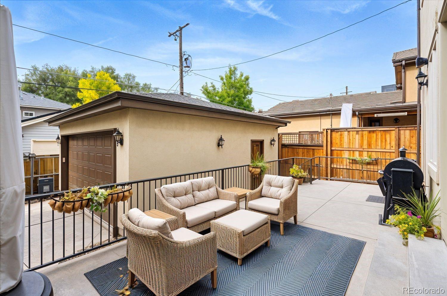 2415 South Madison Street Denver, CO 80210 - Photo 34 of 37 a balcony with furniture and a potted plant