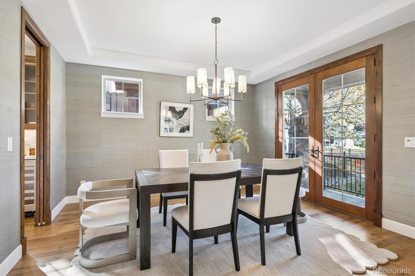 2415 South Madison Street Denver, CO 80210 - Photo 6 of 37 a dining room with furniture a chandelier and wooden floor