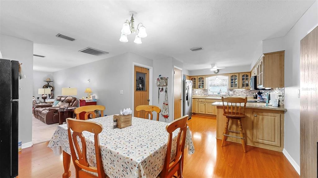 38919 3rd Avenue Zephyrhills, FL 33542 - Photo 11 of 36 a view of a dining room with furniture and wooden floor