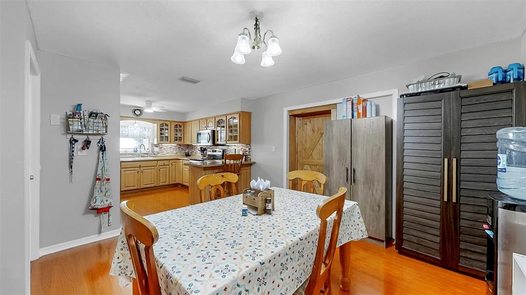 38919 3rd Avenue Zephyrhills, FL 33542 - Photo 12 of 36 a kitchen with stainless steel appliances granite countertop sink stove refrigerator and wooden floor