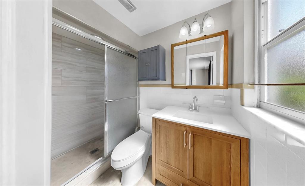 38919 3rd Avenue Zephyrhills, FL 33542 - Photo 14 of 36 a bathroom with a granite countertop sink toilet and shower