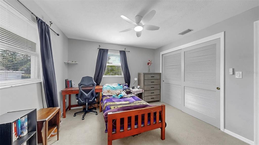 38919 3rd Avenue Zephyrhills, FL 33542 - Photo 16 of 36 a living room with furniture a window and a flat screen tv