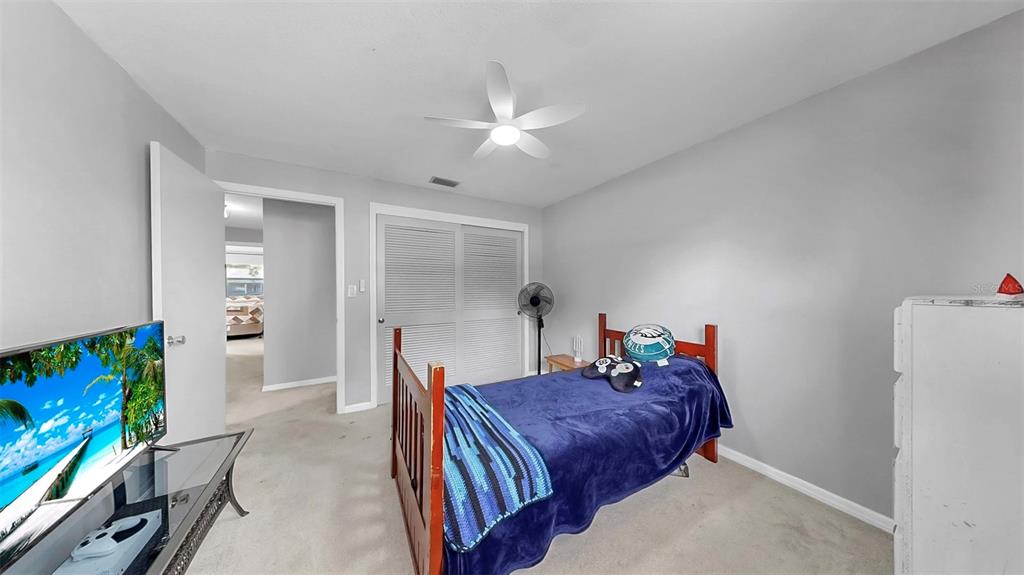 38919 3rd Avenue Zephyrhills, FL 33542 - Photo 18 of 36 a bed room with a bed and a flat screen tv
