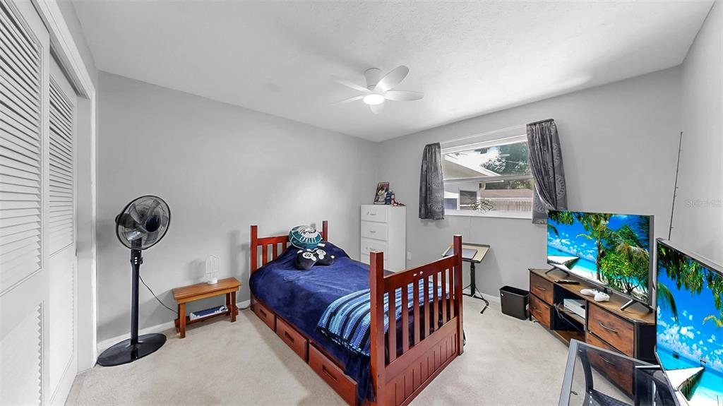 38919 3rd Avenue Zephyrhills, FL 33542 - Photo 19 of 36 a living room with furniture and a flat screen tv