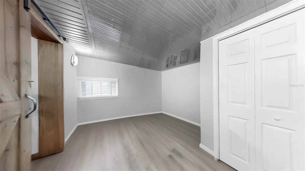 38919 3rd Avenue Zephyrhills, FL 33542 - Photo 20 of 36 an empty room with wooden floor and windows
