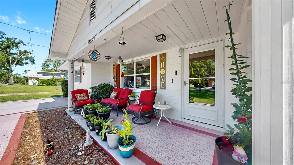 38919 3rd Avenue Zephyrhills, FL 33542 - Photo 2 of 36 a front view of a house with a porch and garden