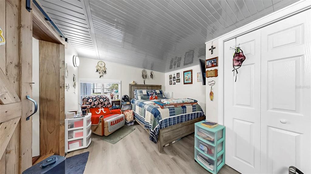 38919 3rd Avenue Zephyrhills, FL 33542 - Photo 21 of 36 a bedroom with bed and a couch