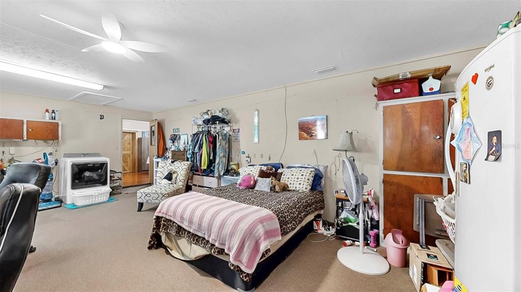 38919 3rd Avenue Zephyrhills, FL 33542 - Photo 22 of 36 a spacious bedroom with a bed and a flat screen tv