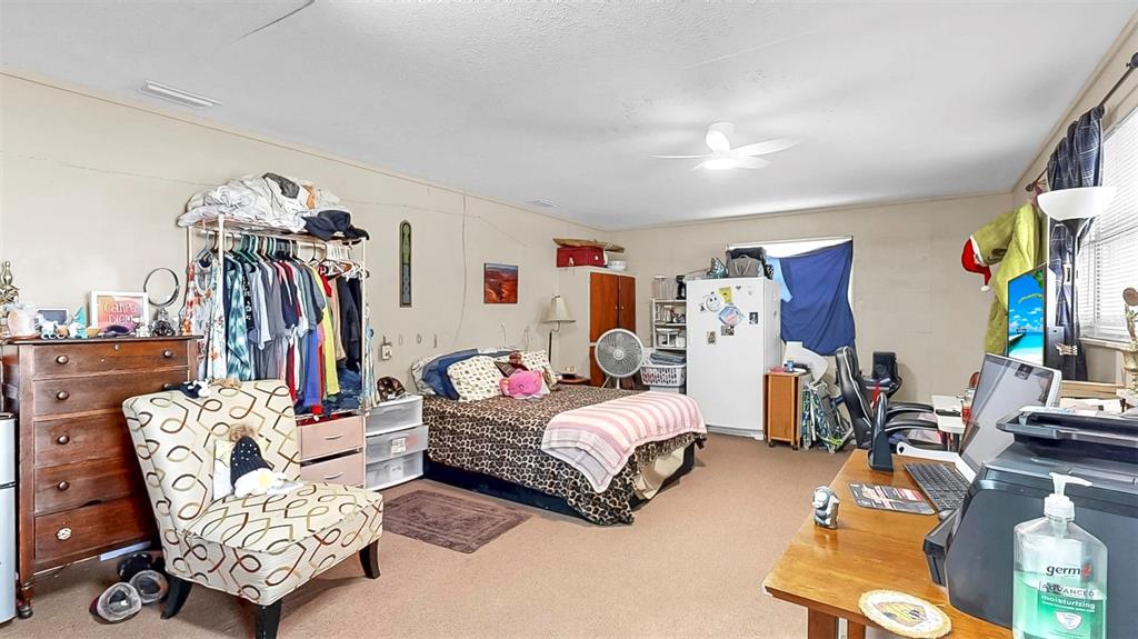 38919 3rd Avenue Zephyrhills, FL 33542 - Photo 23 of 36 a bedroom with furniture and a gym equipment