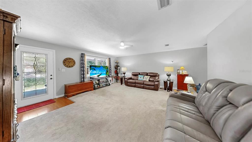 38919 3rd Avenue Zephyrhills, FL 33542 - Photo 3 of 36 a living room with furniture and a flat screen tv
