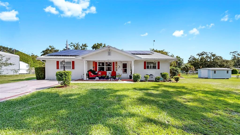 38919 3rd Avenue Zephyrhills, FL 33542 - Photo 33 of 36 a front view of a house with a yard and trees