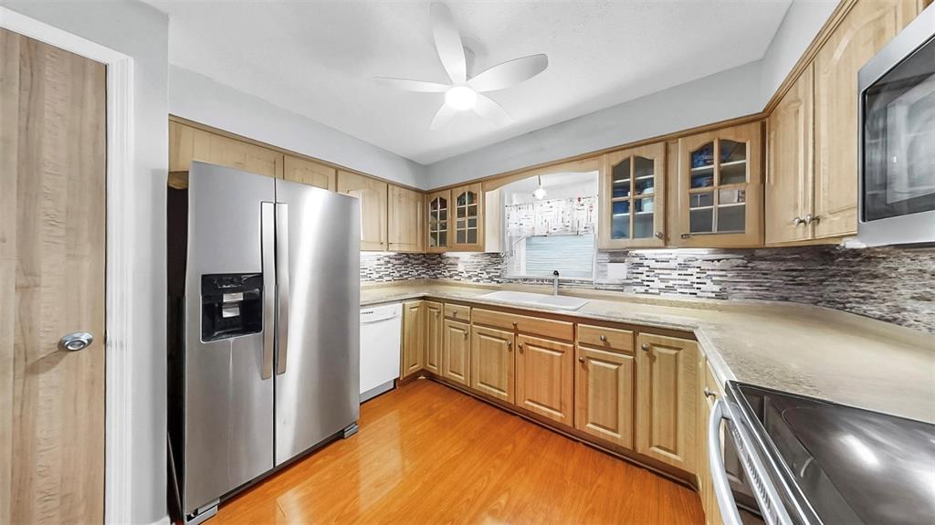 38919 3rd Avenue Zephyrhills, FL 33542 - Photo 6 of 36 a kitchen with stainless steel appliances granite countertop a refrigerator and a sink