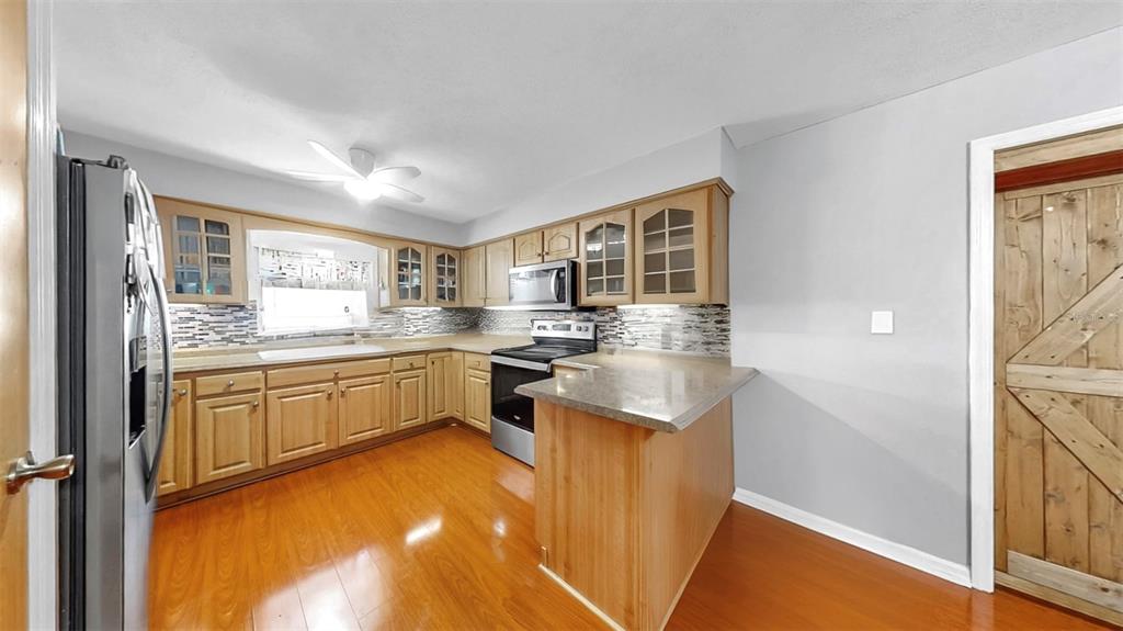 38919 3rd Avenue Zephyrhills, FL 33542 - Photo 10 of 36 a kitchen with stainless steel appliances granite countertop a sink and cabinets