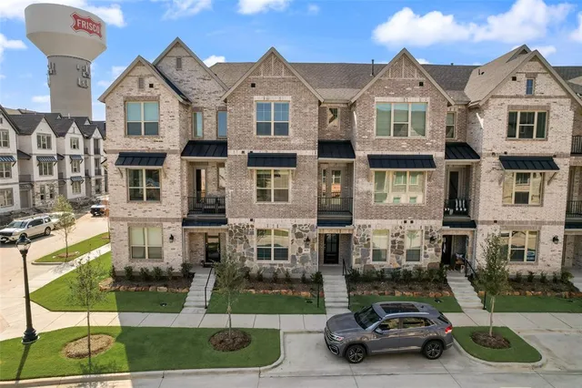 a car parked in front of a brick house
