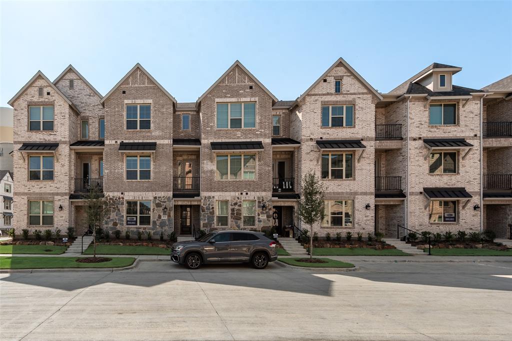 a car parked in front of a big house