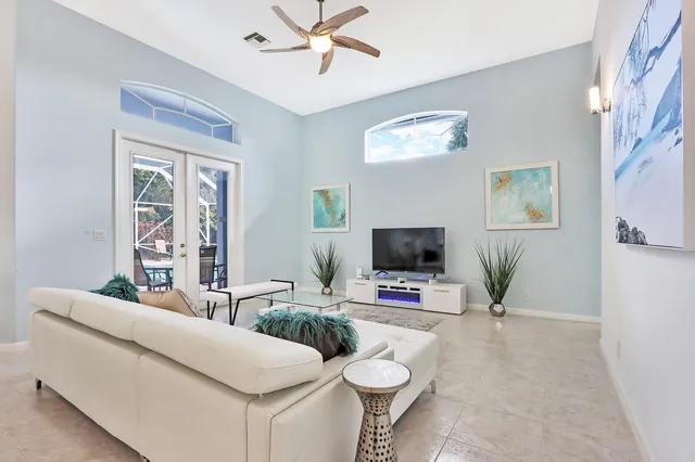 a living room with furniture and a potted plant