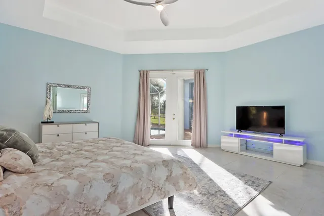 a bedroom with a bed and a flat screen tv