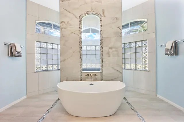 a white bath tub sitting next to a window