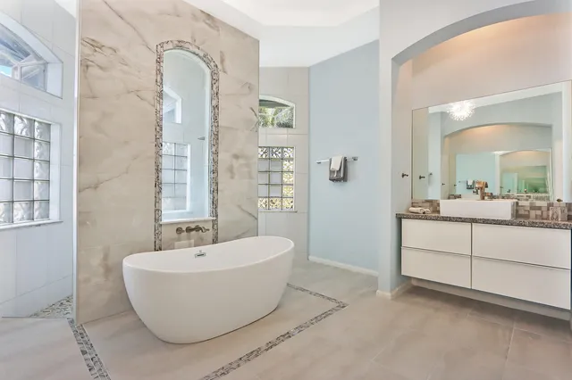 a spacious bathroom with a bathtub and mirror