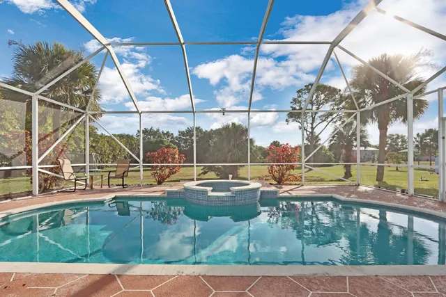 a view of a swimming pool with a lounge chairs
