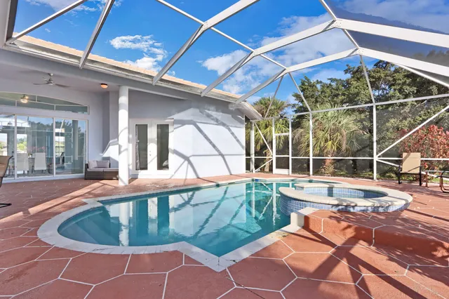 a view of a swimming pool with outdoor seating