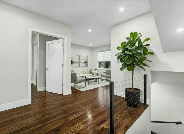 a living room with furniture and a potted plant