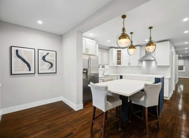 a view of a dining room with furniture wooden floor and chandelier