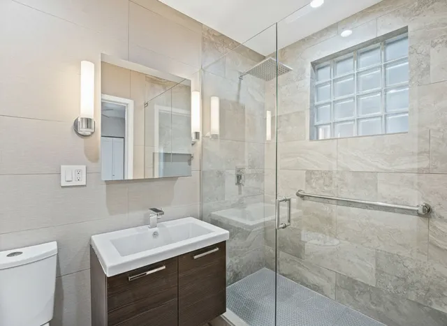 a bathroom with a sink toilet and shower