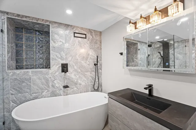 a bathroom with a bathtub and shower