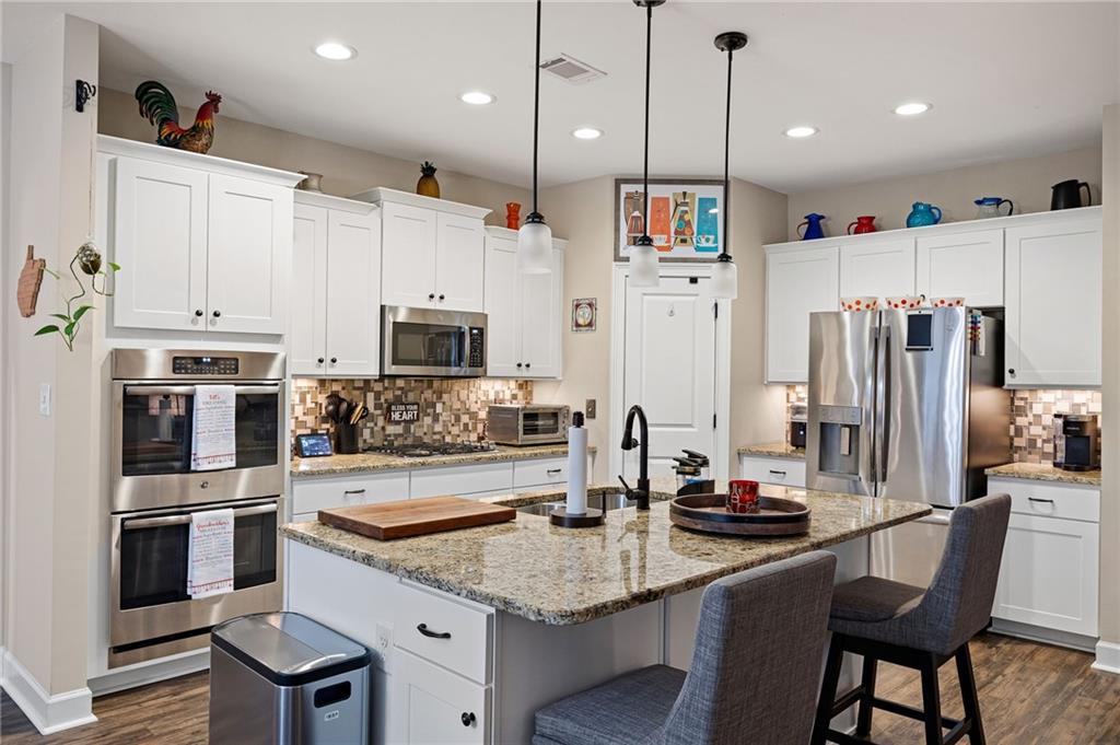 102 Kirk Drive Dallas, GA 30132 - Photo 11 of 28 a kitchen with stainless steel appliances granite countertop a sink refrigerator and cabinets