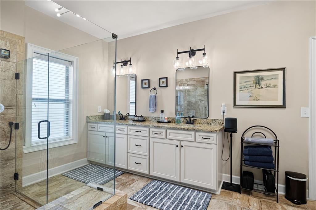 102 Kirk Drive Dallas, GA 30132 - Photo 16 of 28 a spacious bathroom with a granite countertop sink a toilet and a mirror