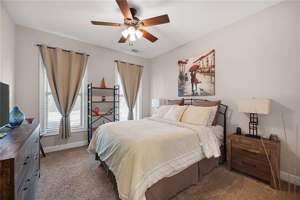 102 Kirk Drive Dallas, GA 30132 - Photo 18 of 28 a bedroom with a bed a couch and a chandelier