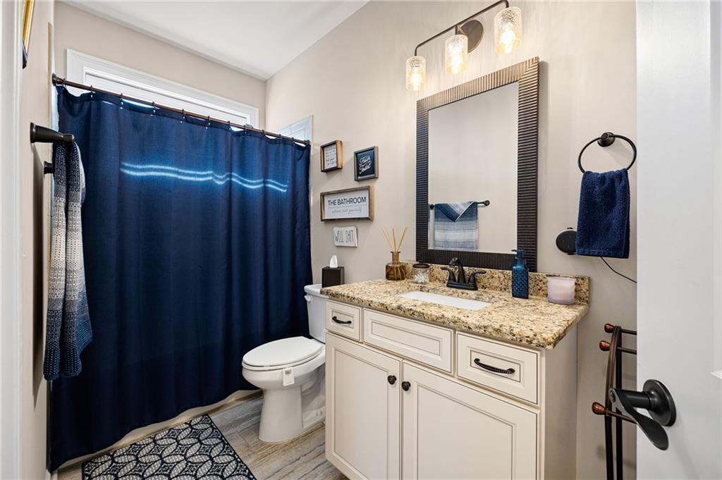 102 Kirk Drive Dallas, GA 30132 - Photo 19 of 28 a bathroom with a granite countertop sink toilet and mirror