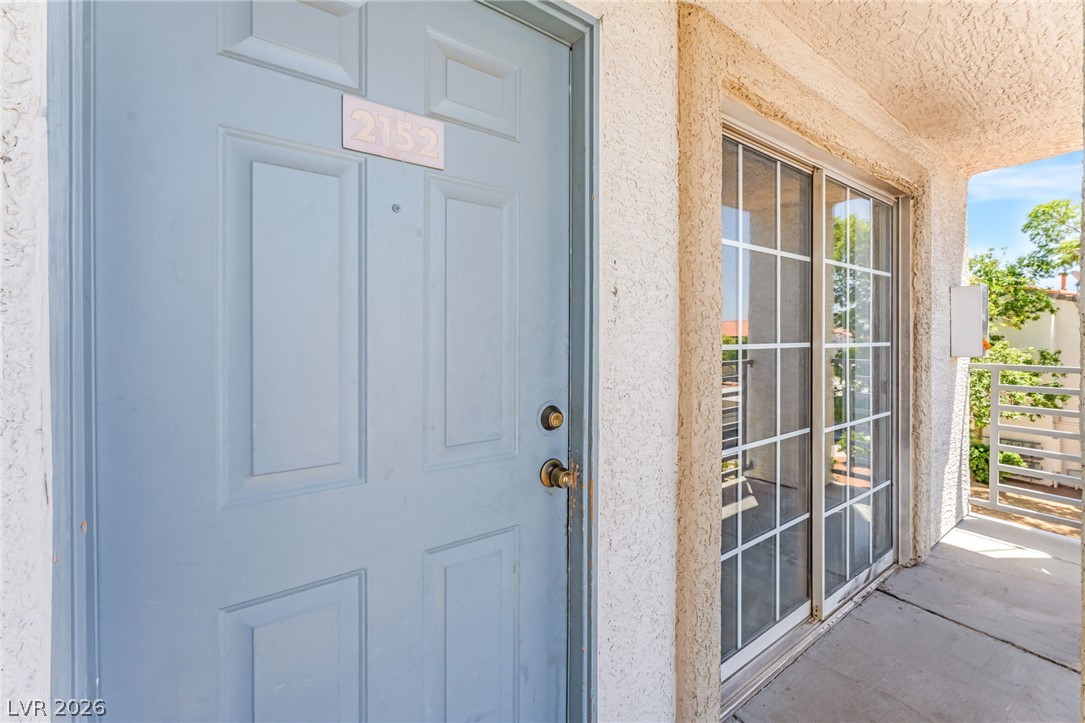 3318 North Decatur Boulevard, Unit 2152 Las Vegas, NV 89130 - Photo 6 of 58 Secure entry via a panel door and adjacent sliding glass doors provide access to this home's exterior.