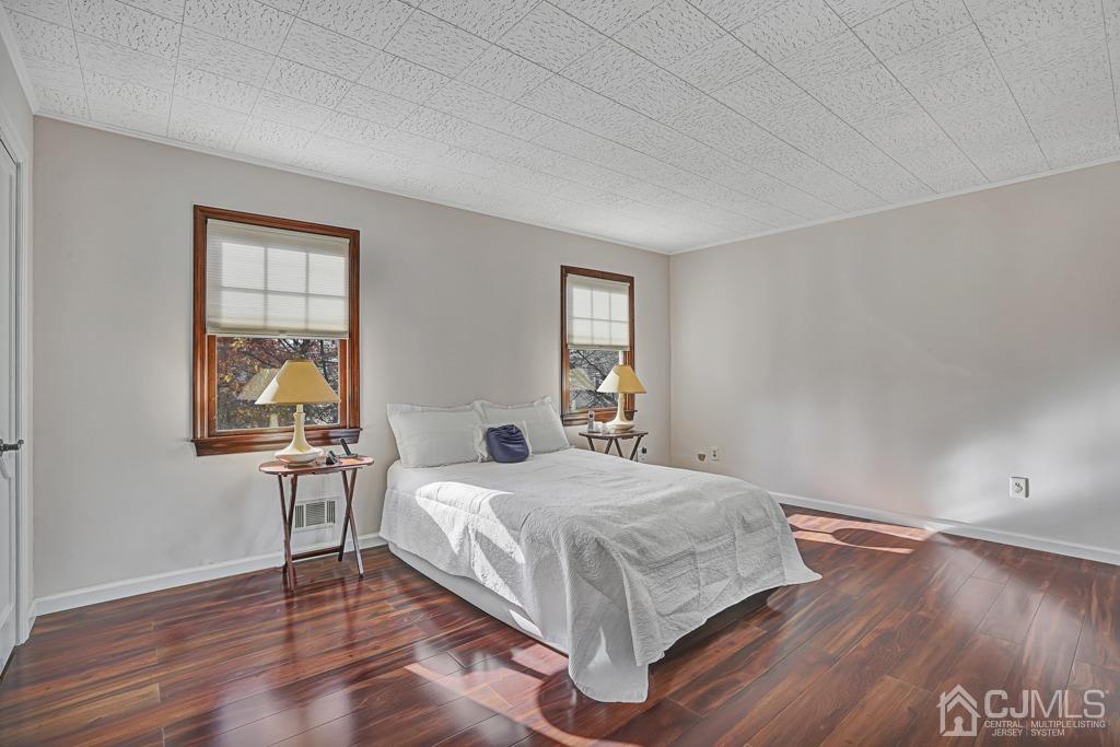 134 Benart Place Middlesex, NJ 08846 - Photo 12 of 28 a bedroom with a bed and wooden floor