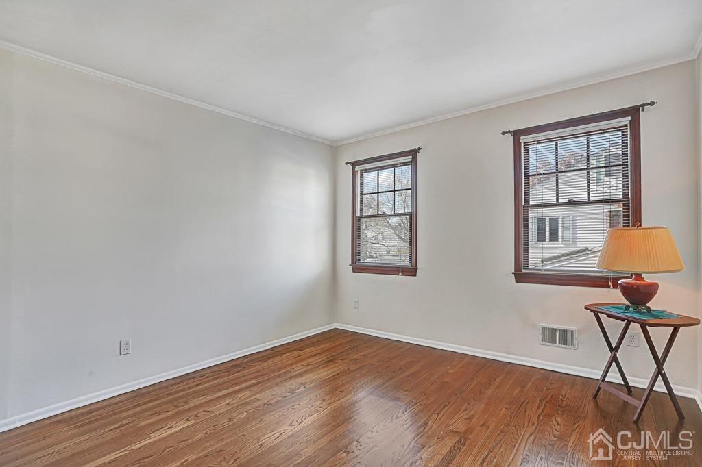 134 Benart Place Middlesex, NJ 08846 - Photo 16 of 28 a view of an empty room with window and wooden floor