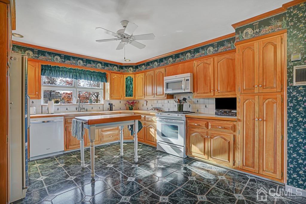 134 Benart Place Middlesex, NJ 08846 - Photo 10 of 28 a kitchen with refrigerator cabinets and windows