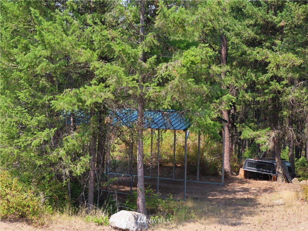 94 East Lilly Creek Road Republic, WA 99166 - Photo 14 of 20 a backyard of a house with table and chairs