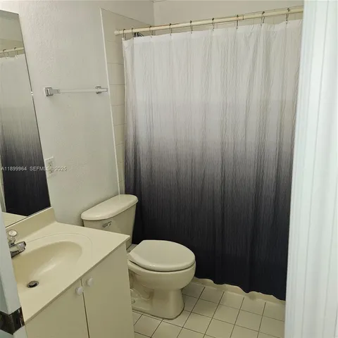 a white toilet sitting next to a bathroom sink