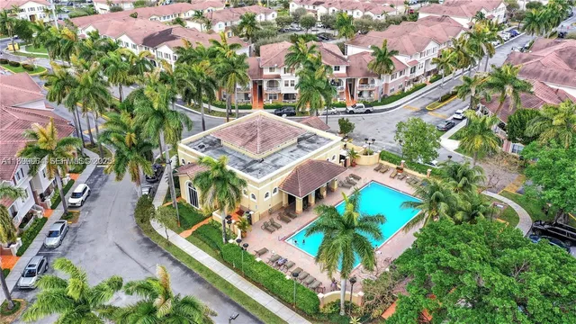 an aerial view of a house with a yard and potted plants