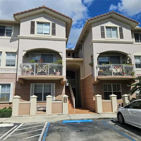 a front view of a building with parking space and parking