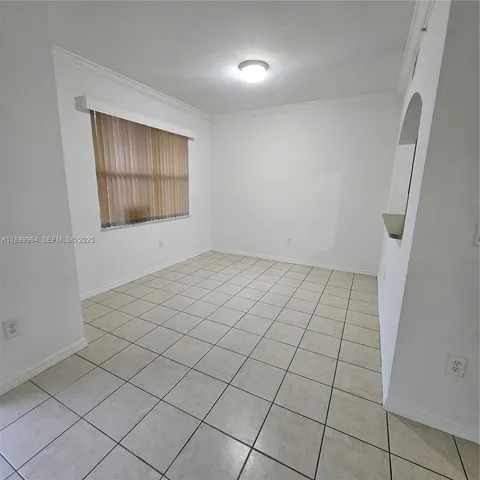 a view of an empty room and wooden floor