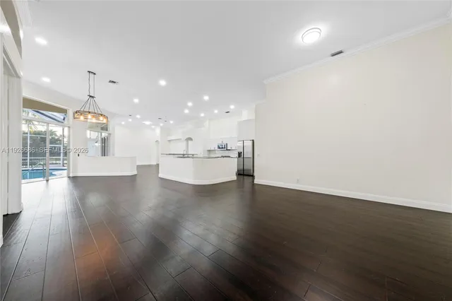 a view of a kitchen with a sink and wooden floor