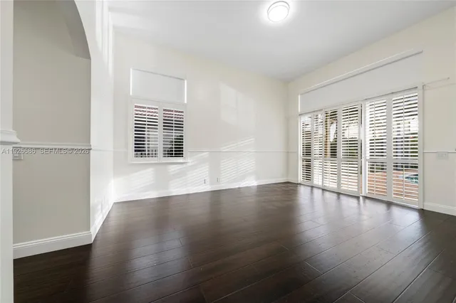 a spacious bedroom with a bed and a large window