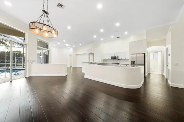 a view of a kitchen with cabinets and wooden floor