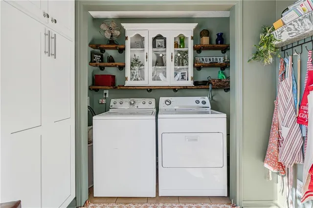 a kitchen with stainless steel appliances kitchen island granite countertop dining table chairs and a refrigerator